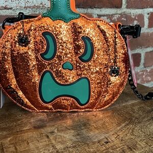 Betsy Johnson glow-in-the-dark pumpkin pocketbook, different face on each side